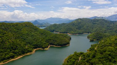 Tropical landscape: A mountain lake among beautiful mountains with forest. Victoria Reservoir, Sri Lanka.