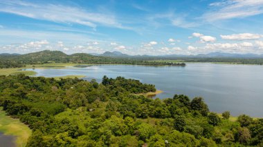 Sorabora lake in a mountain valley among the hills. Sri Lanka.