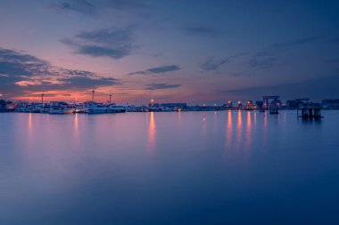 Belçika 'nın Nieuwpoort kentindeki IJzer nehrinin mavi saatiyle gün batımının güzel manzarası.