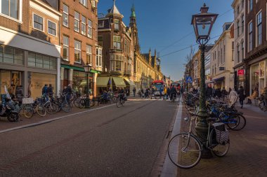 Leiden, Hollanda - 5 Mart 2022 Leiden 'da sokak sahnesi. İnsanlar Leiden 'ın merkezindeki Breestraat' tan alışveriş yapıp bisiklete biniyorlar..
