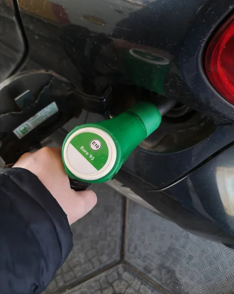 Close Hand Holding Green Gasoline Fuel Nozzle Being Filling Gas — Stock Photo, Image