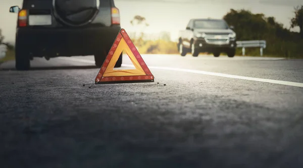 Red emergency stop sign (red triangle warning sign) and broken b