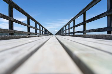 Long leading lines of never ending jetty from deck level on Motuihe Island , Auckland New zealand.