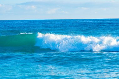 Breaking waves on Main Beach Mount Maunganui, New Zealand.