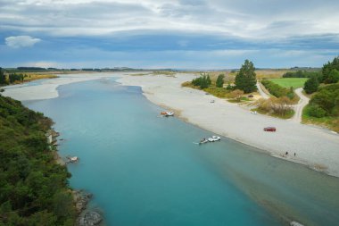 Canterbury New Zealand - May 7 2022; Waimakariri River flowing through landscape towards coast clipart