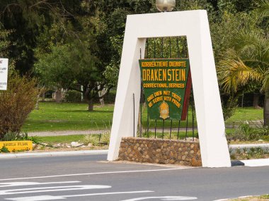 Paarl South Africa - September 23 2007; White arch structure with green and yellow sign for Drakenstein prison where Nelson Mandela was imprisoned for a time.