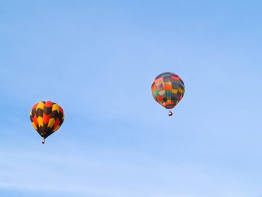 Hamilton New Zealand - April 12 2008; Highly coloured hot air balloons taking off at festival flying high.