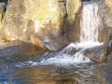Stream and waterfall over rocks at McLaren Falls Park and Lake.