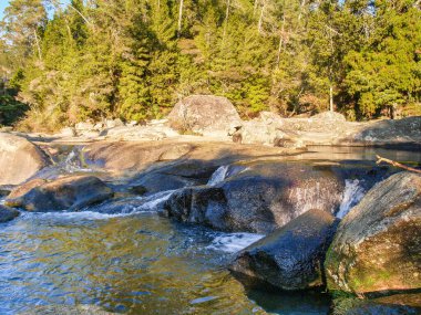 Stream and waterfall over rocks at McLaren Falls Park and Lake.