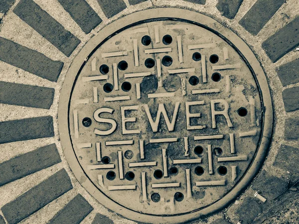 Grimy Sewer Manhole Cover City Street Monochrome — Stok fotoğraf