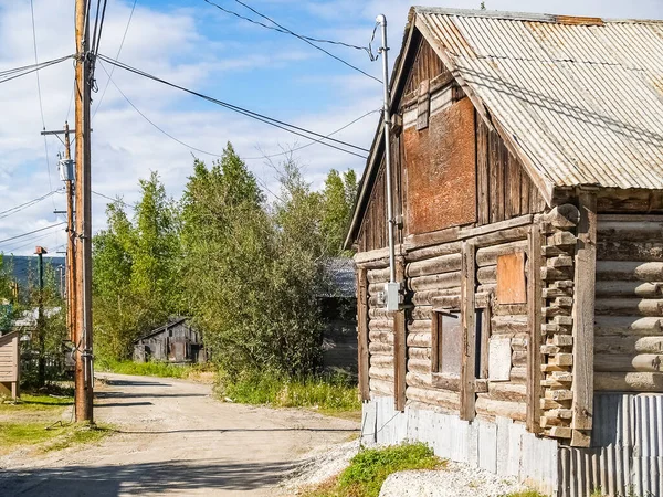 Log cabin style building in dusty town street in historic mining Yukon Territory, Dawson City.
