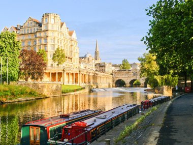 Avon Nehri boyunca geleneksel mimari binalar ve İngiltere 'nin Bath kentinde demirlemiş uzun botlar.