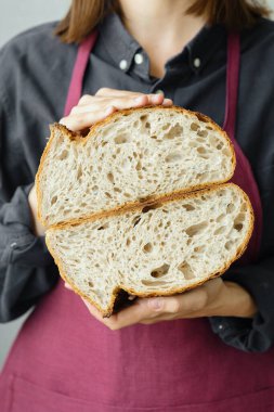 Mayasız ekşi ekmek. Avrupalı güzel bir fırıncı elinde ekmek tutuyor.
