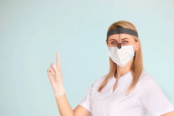 Female ENT doctor, wearing in mask at the hospital looking at the camera