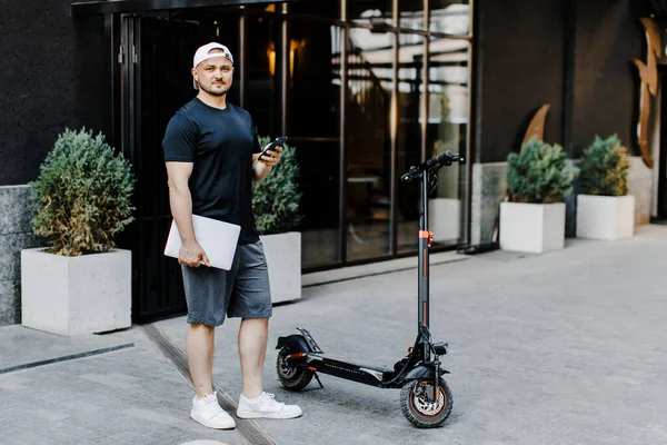 Handsome Freelancer Holding Laptop Phone Hands Electric Scooter Street — 图库照片