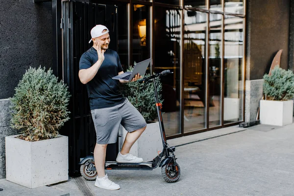 Caucasian Man Standing Outdoor Street Electric Scooter Videochatting Laptop Computer — 图库照片