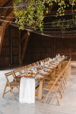 A beautifully set table for celebrating a party. Tableware sets for guests. Decor for a wedding celebration