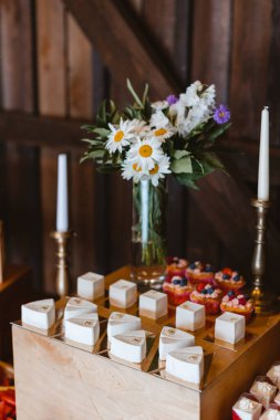 Candy bar. Festively decorated buffet table for guests. A stand with a variety of desserts for celebrating a party