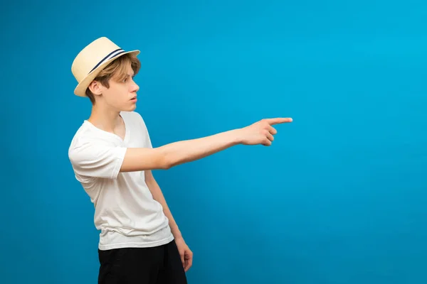 Young Teen Man Points Palms Aside Isolated Blue Friendly Well — Stock Photo, Image