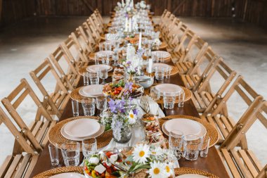 A beautifully set table for celebrating a party. Tableware sets for guests. Decor for a wedding celebration