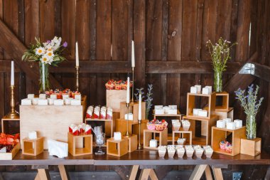Candy bar. Festively decorated buffet table for guests. A stand with a variety of desserts for celebrating a party
