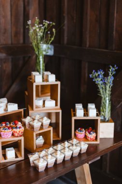 Candy bar. Festively decorated buffet table for guests. A stand with a variety of desserts for celebrating a party