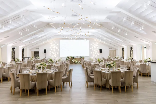 Tables setting at a luxury wedding. Table for guests. Dishes and drinks. Wedding table preparation.