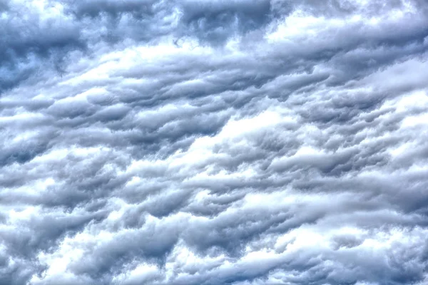 Dönen bulutlar batan güneş tarafından aydınlatılıyor