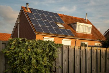 Güneş panelleri olan modern Hollanda evi çatısı, evler için yenilenebilir enerji