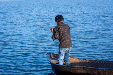 TIKAMGARH, MADHYA PRADESH, INDIA - JUNE 05, 2022: Indian boy boating in the river.