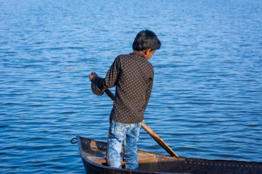 TIKAMGARH, MADHYA PRADESH, INDIA - JUNE 05, 2022: Indian boy boating in the river.
