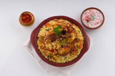 Chicken biryani , Kerala style chicken dum biriyani made using jeera rice and spices arranged in  earthen ware  on white background, isolated clipart