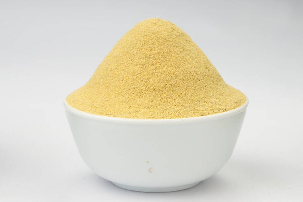Fenugreek powder, Indian spice;arranged in a white bowl with white textured background