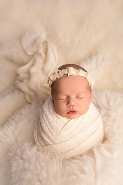 Menina recém-nascida adormecida nos primeiros dias de vida em um casulo branco com uma bandagem branca em um fundo branco. Fotografia macro de estúdio, retrato de um recém-nascido. O conceito de felicidade feminina. — Fotografia de Stock