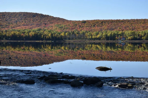 Reflection on the lake in autumn, Lac Frontiere, Quebec Canada