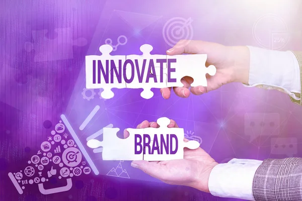 Conceptual caption Innovate Brand. Business idea significant to innovate products, services and more Hand Holding Jigsaw Puzzle Piece Unlocking New Futuristic Technologies.