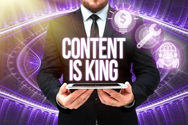 Rukopis Content Is King. Word for marketing focused growing visibility non paid search results Man In Office Uniform Holding Tablet Displaying New Modern Technology. — Stock fotografie