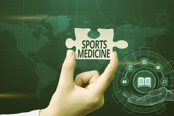 Hand writing sign Sports Medicine. Word Written on treatment and prevention of injuries related to sports Hand Holding Jigsaw Puzzle Piece Unlocking New Futuristic Technologies.