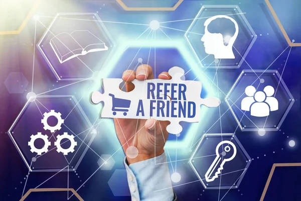 Handwriting text Refer A Friend. Business approach direct someone to another or send him something like gift Hand Holding Jigsaw Puzzle Piece Unlocking New Futuristic Technologies. — Stock Photo, Image