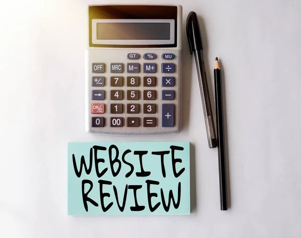 Hand writing sign Website Review. Business overview Reviews that can be posted about businesses and services Blank Open Spiral Notebook With A Calculator And A Pen On Table. — Stock Photo, Image