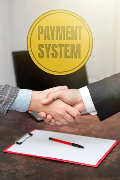 Handwriting text Payment System. Concept meaning Compensation Scheme Method used in paying goods and services Two Professional Well-Dressed Corporate Businessmen Handshake Indoors