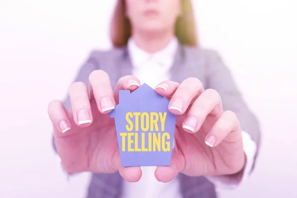 Text sign showing Story Telling. Word for activity writing stories for publishing them to public A Young Lady Businesswoman Holding Presenting Home In Business Outfit