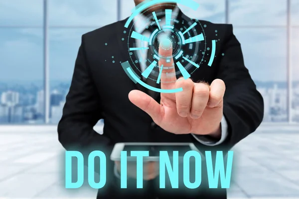 Text sign showing Do It Now. Business approach not hesitate and start working or doing stuff right away Man In Uniform Standing Holding Tablet Typing Futuristic Technologies. — Stock Photo, Image