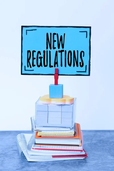 Hand writing sign New Regulations question. Conceptual photo rules made government order to control way something is done Organized And Neat Sorting Arrangement Files And Document Storing Ideas