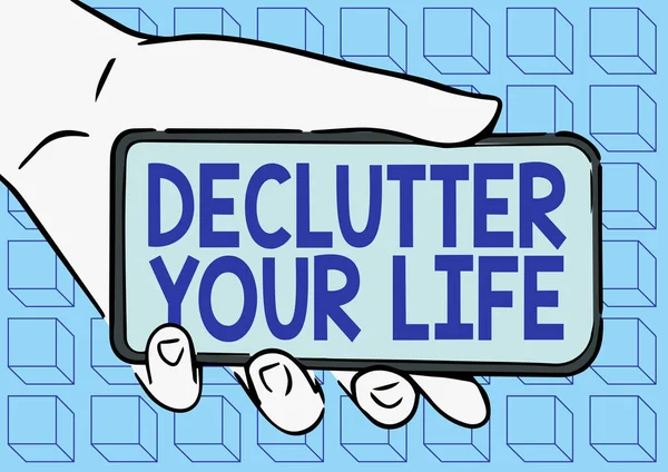 Kézírás szöveg Declutter Your Life. Word Written on To eliminating extraneous things or information in life Felnőtt kéz illusztráció Holding Mobile Új technológia megjelenítése a képernyőn. — Stock Fotó