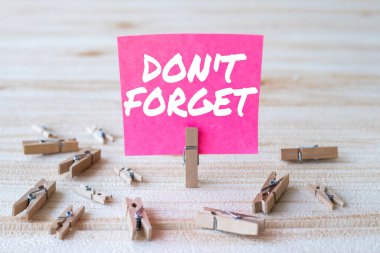 El yazısı metni, unutma. Yeni Fikir Gösteren Çamaşır Klipleriyle çevrili Önemli bir gerçeği veya detayı hatırlatmak için iş genel görünümü.