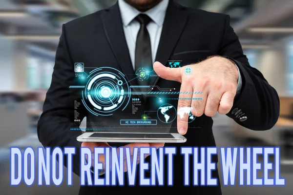Handwriting text Do Not Reinvent The Wheel. Business concept stop duplicating a basic method previously done Man In Uniform Standing Holding Tablet Typing Futuristic Technologies. — Stock Photo, Image