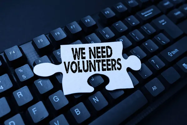 Sign displaying We Need Volunteers. Business approach someone who does work without being paid for it Creating Online Journals, Typing New Articles, Making New Headlines