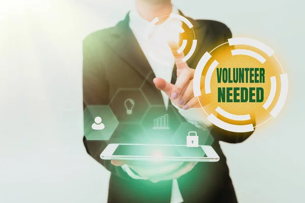 Handwriting text Volunteer Needed. Concept meaning asking person to work for organization without being paid Woman In Uniform Holding Mobile Phone Showing Futuristic Virtual Icons — Stock Photo, Image
