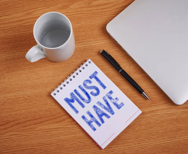 Tekst bijschrift presenteren Must Have. Zakelijke aanpak iets moderns dat velen tonen willen Essentiële item Gesloten Laptop Naast Lege Journal met Pen en Koffie mok Over tafel. — Stockfoto